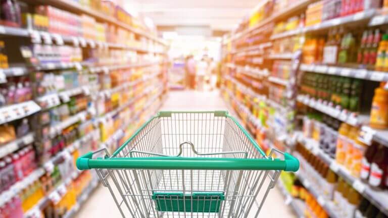 An empty trolley in a supermarket aisle