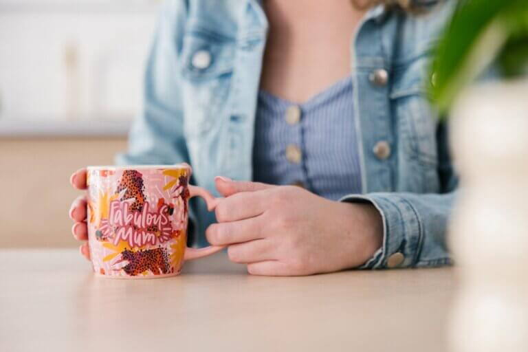 MyBudget client Erin holding a 'fabulous mum' mug for Mother's Day