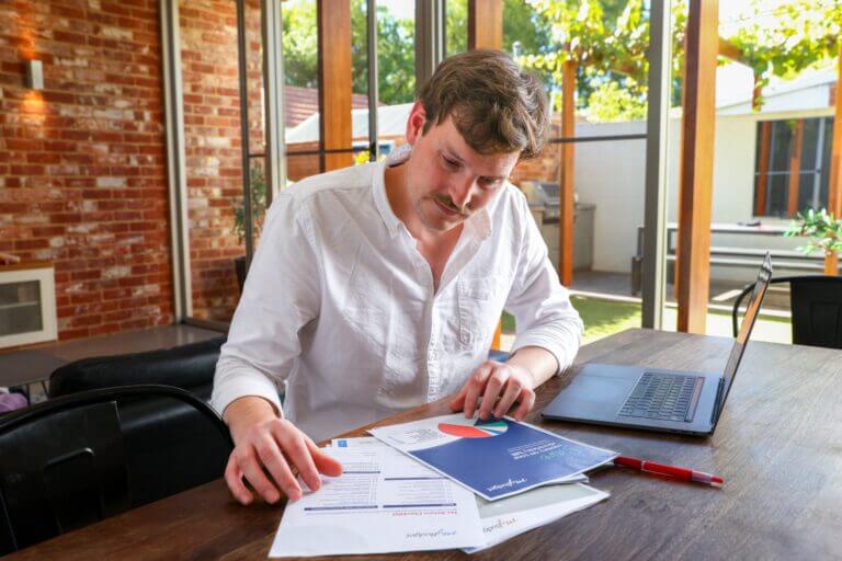 A debt stressed man looking at the MyBudget resources to help get out of debt and start saving
