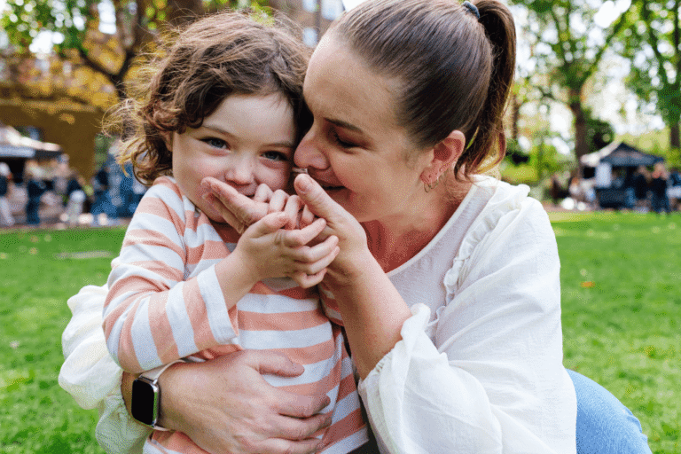 A single mum hugging her daughter at the park