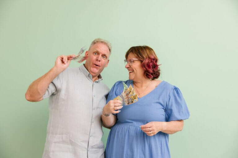 Michelle and Phil, MyBudget clients, holding money and saving with MyBudget