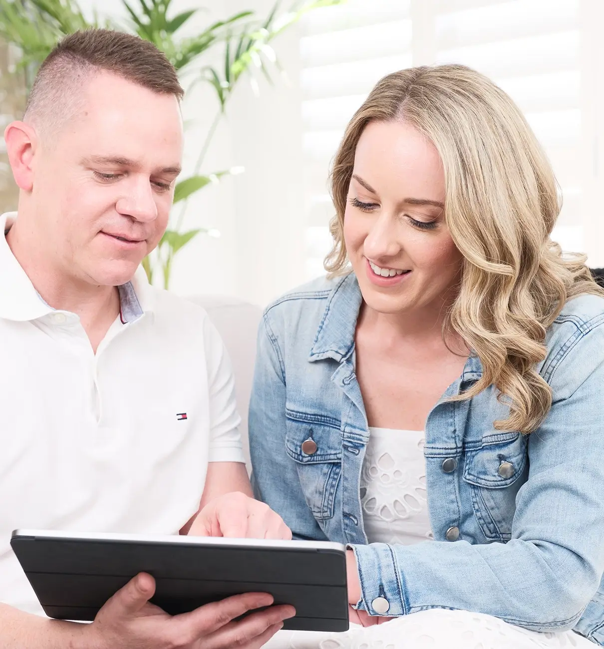 MyBudget clients Adam and Erin reviewing their personal budget and debt solutions using the MyBudget app in New Zealand.