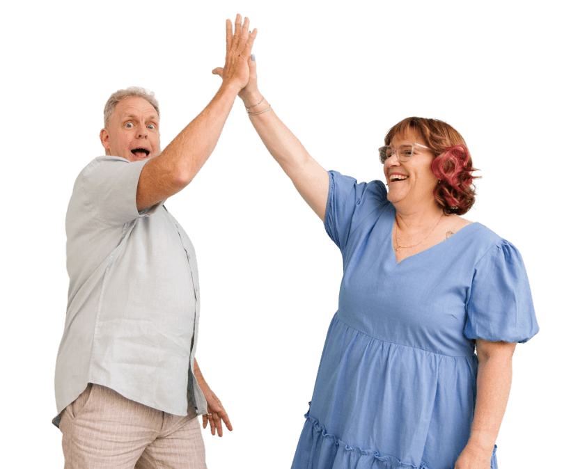 A happy couple, Michelle and Phil, clients of MyBudget, are captured mid-high-five, celebrating their financial success and effective budgeting. The man looks surprised and excited, while the woman is smiling broadly, highlighting the positive results of using MyBudget services to achieve their financial goals in New Zealand. This image represents the satisfaction and relief of managing personal finances effectively.