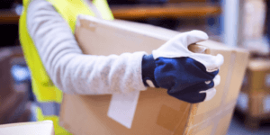 A person holding a taped up moving box