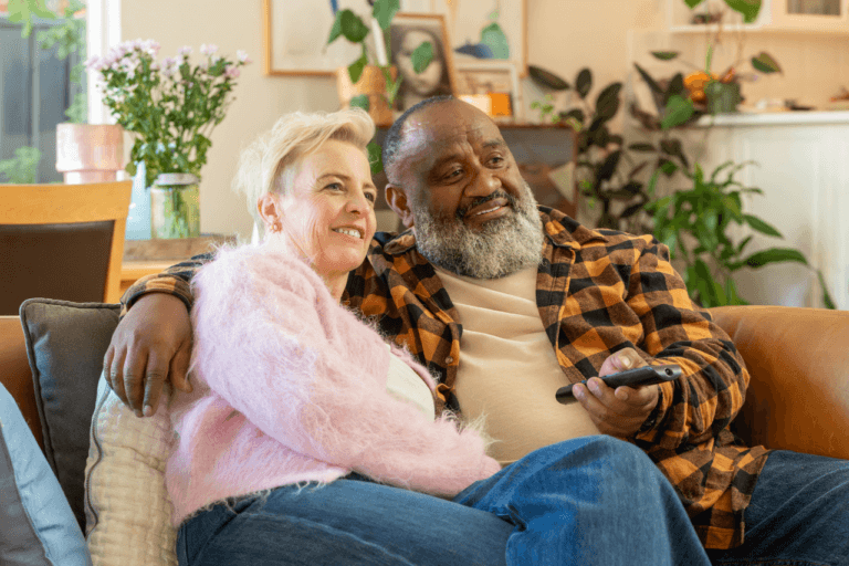 Kim and Bob relaxing at home after achieving greater financial confidence with MyBudget, inspiring New Zealanders to take control of their money.